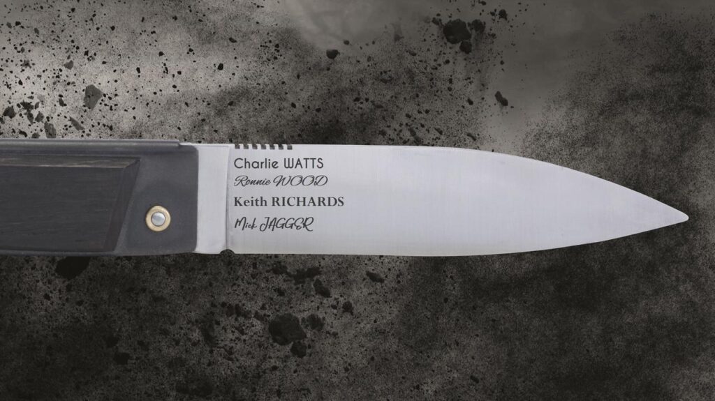 An elegant knife blade featuring precisely executed custom engraving of iconic names, enhancing the blade's surface with personal or commemorative meaning.