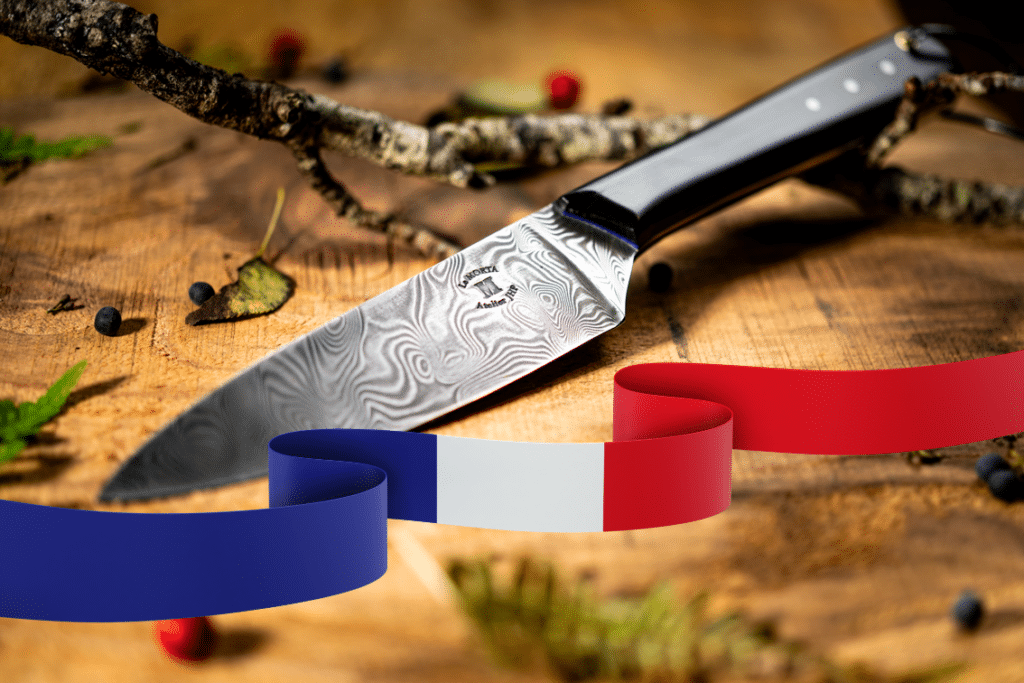 High-quality French chef's knife with damascus steel blade set on a rustic wooden board, adorned with a ribbon in the colors of the French flag, symbolizing its Made in France origin.